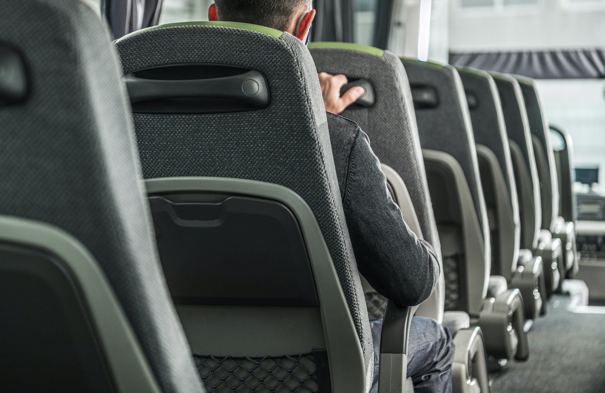 Passengers seated on a coach bus during a group transfer